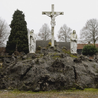 202-De calvarieberg op het kerkhof achter de kerk in Bakel, met drie  gietijzeren beelden: Maria, Christus en Johannes. Dit Rijksmonument stamt uit 1854.