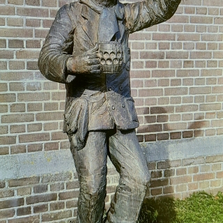 212-In Bakel, aan de Dorpsstraat, aan de voet van de kerk, staat sinds 1996 het “Baokels Pierke”. Kunstenaar: Toon Grassens.